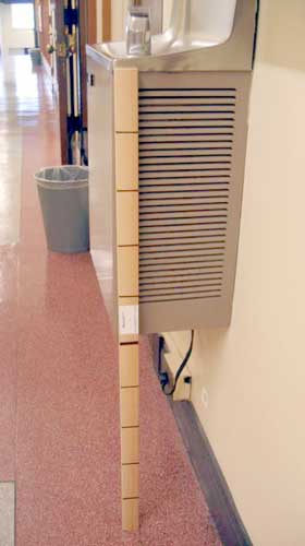 1 metre ruler leaning against public drinking tap